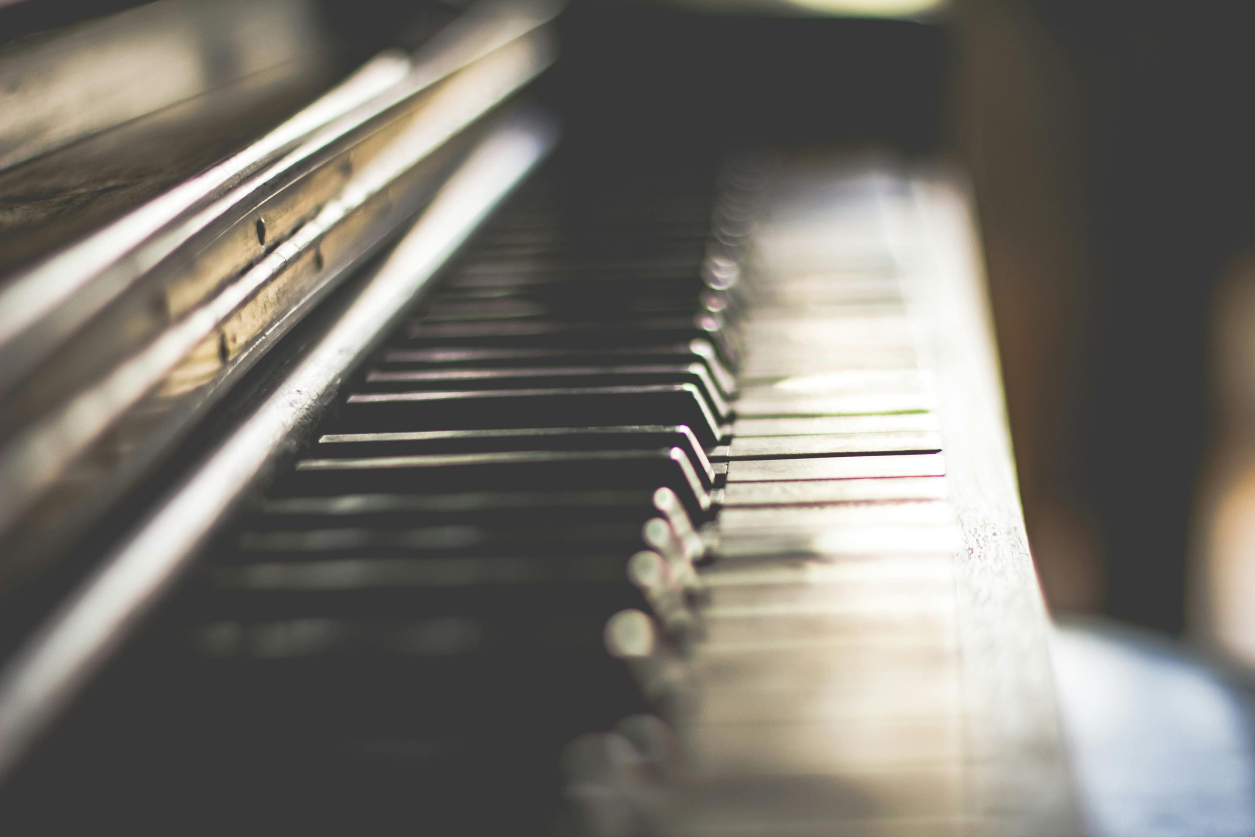 Artistic close-up of piano keys with soft lighting and selective focus. Perfect for music lovers.